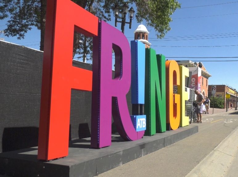 A large FRINGE word-art sculpture in a bike lane during the festival.