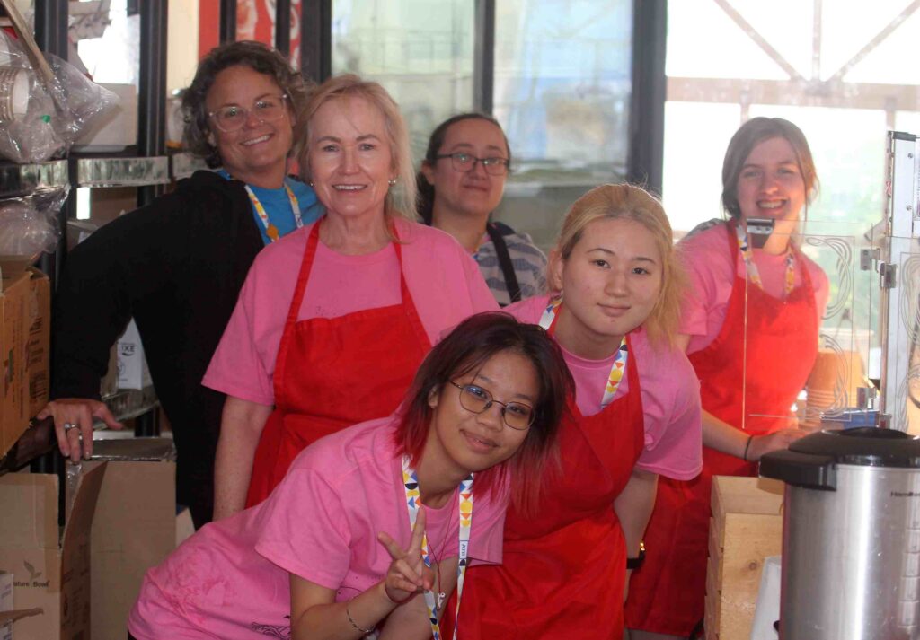 Two Fringe Staff and Four Fringe Volunteers smiling at the camera in the Festival kitchen