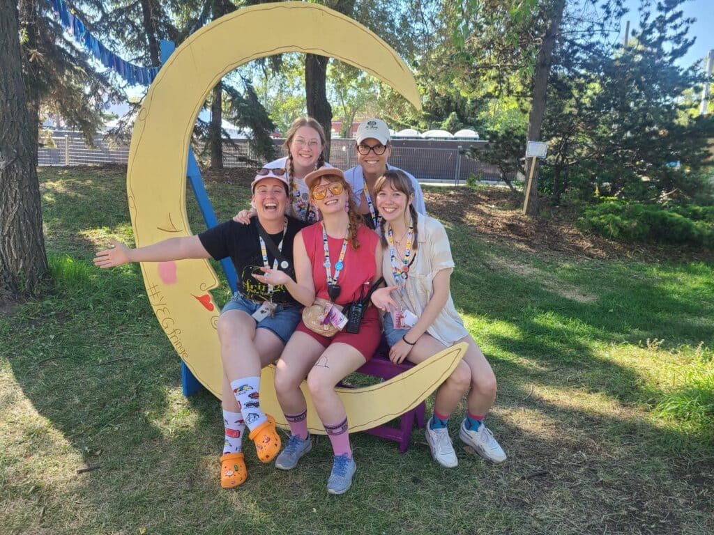 Alyson and KidsFringe Staff pose with a cutout of a moon.