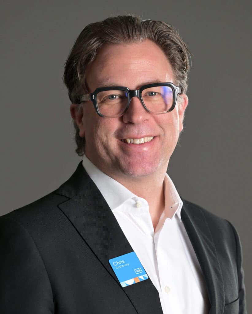 Chris Turchansky headshot. He is wearing a grey suit with an ATB Pin.